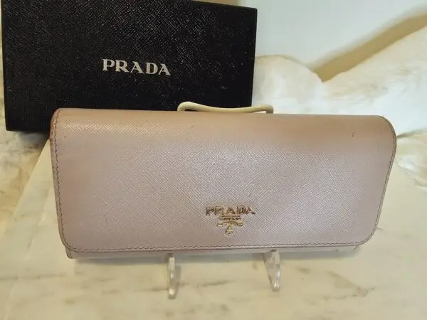 A prada wallet sitting on top of a table.