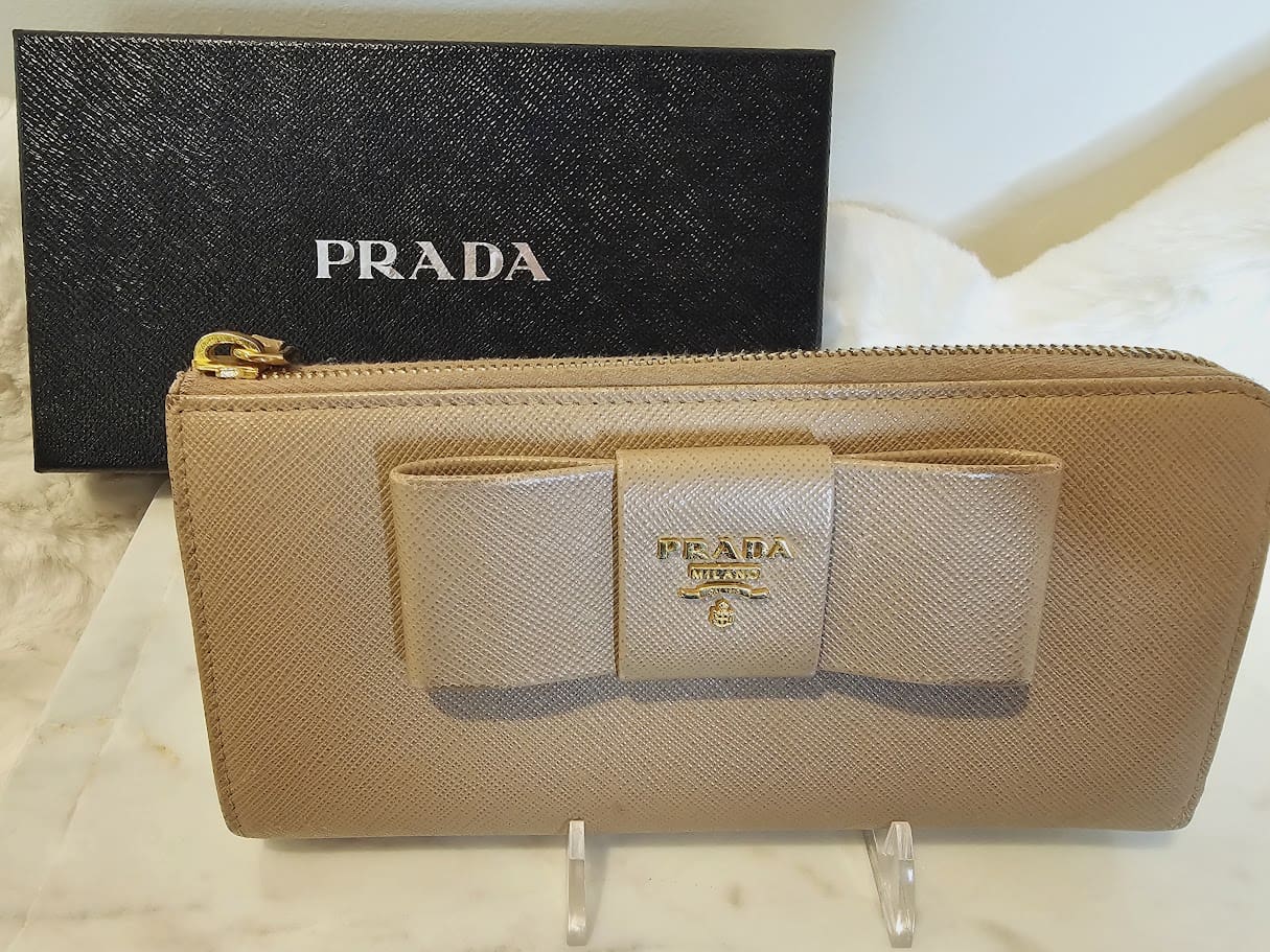 A prada wallet sitting on top of a table.