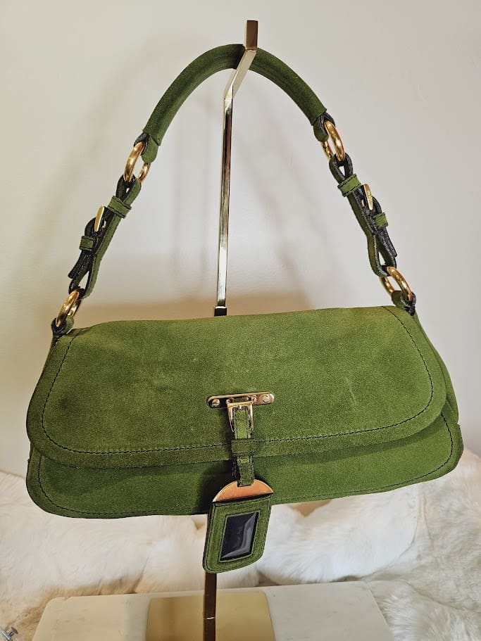 A green purse hanging on the wall