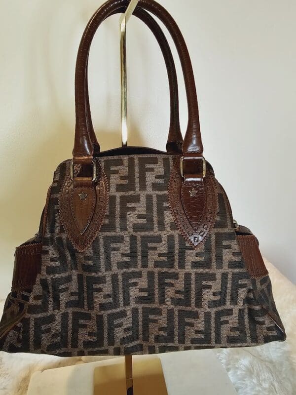 A brown and black bag sitting on top of a table.