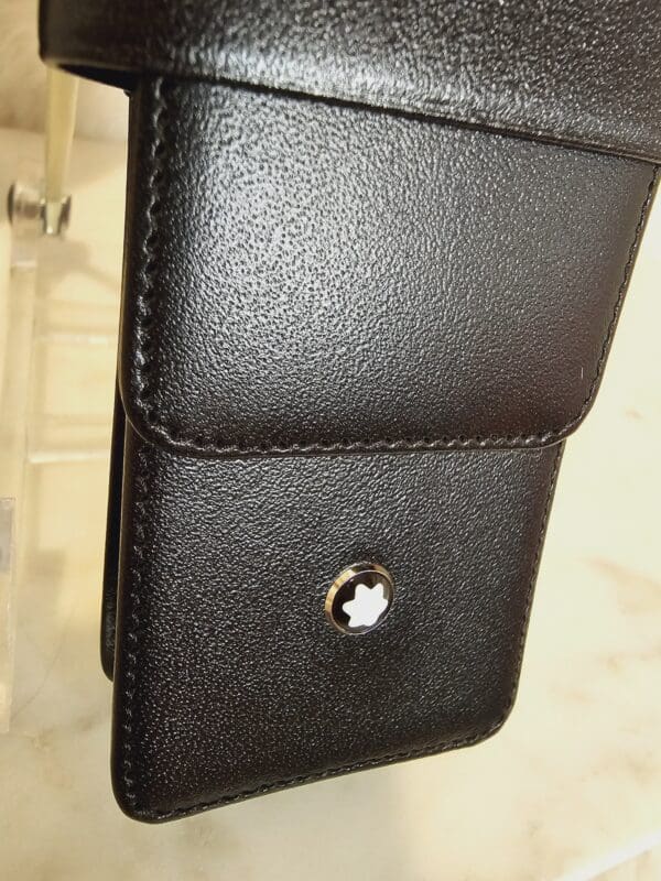 A close up of the leather case on a cell phone