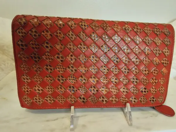 A red purse sitting on top of a table.