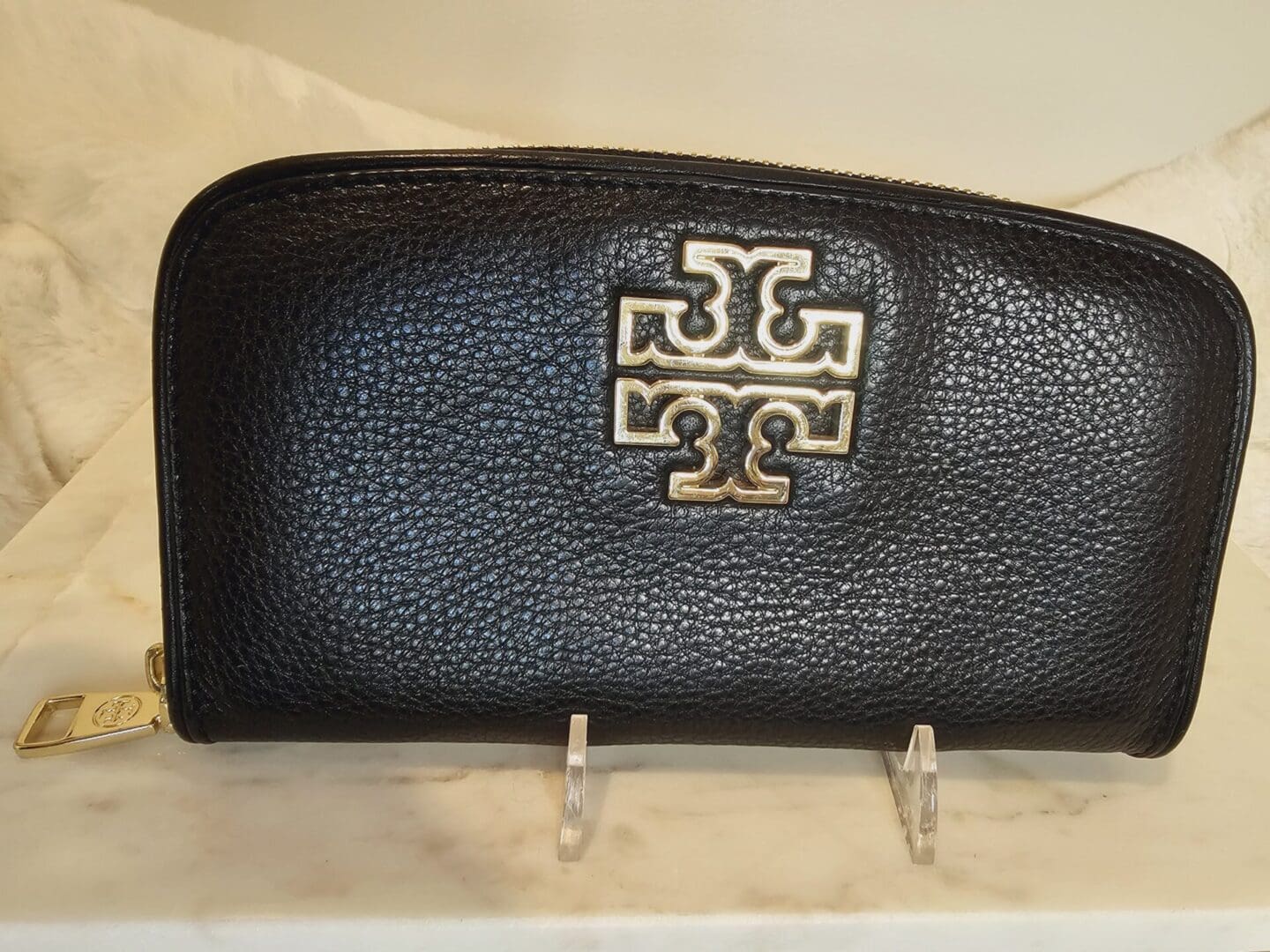 A black purse sitting on top of a counter.