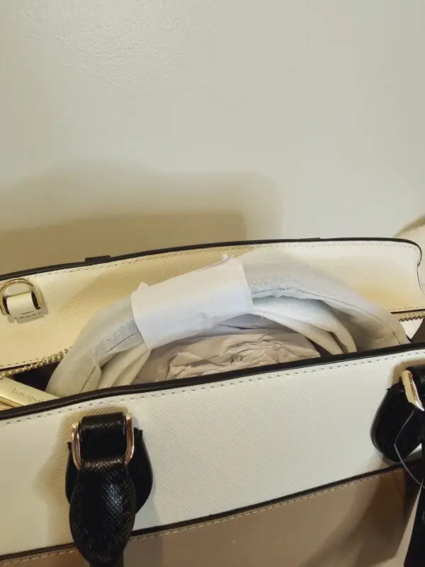 A white purse with some papers in it