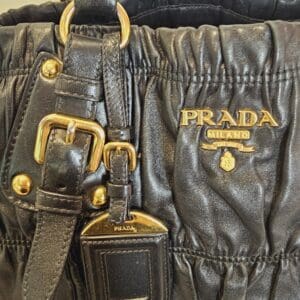 A close up of the prada logo on a bag