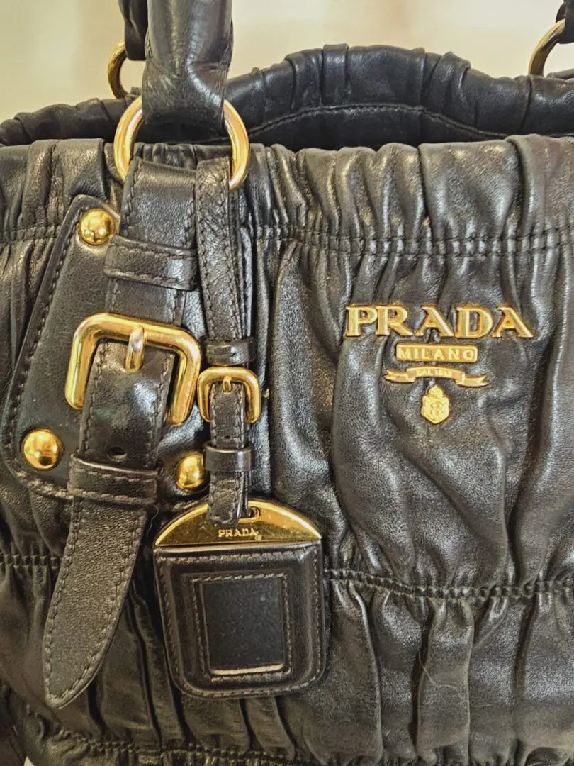 A close up of the prada logo on a bag