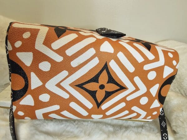 A brown and white bag sitting on top of a fur rug.