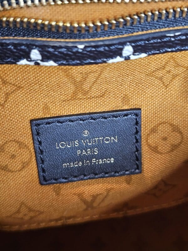 A close up of the louis vuitton label on a bag