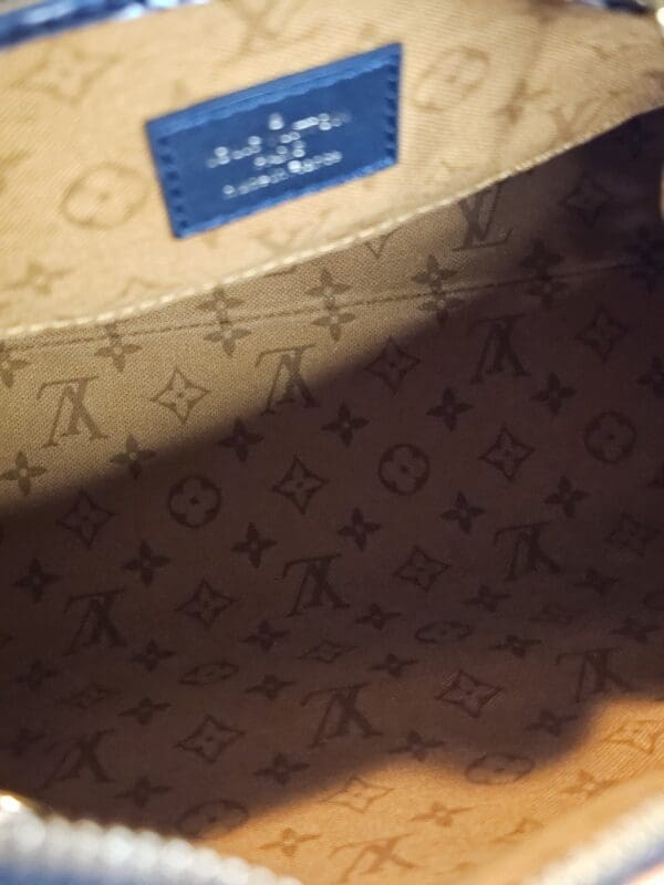 A close up of the bottom of a louis vuitton bag